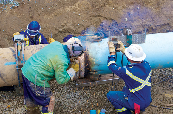 Workers construct a pipeline for the Anchor Loop project, a 158-kilometre section of pipe linking Hinton, Alta. and Hargreaves, BC.  It is installed adjacent to Trans Mountain’s existing pipeline, just west of Mount Robson Provincial Park.